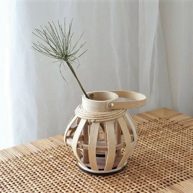 Natural bamboo hand-woven candle holder with dried grass on woven surface